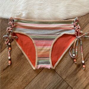 Becca brand bikini bottom with a striped pattern and beaded ties